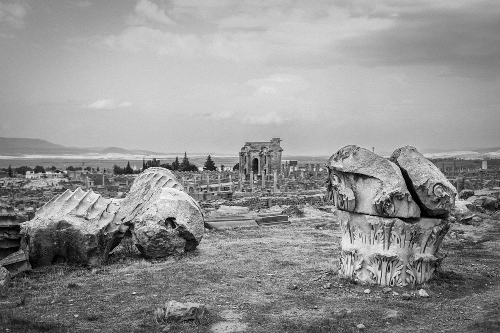Aerial view of desert ruins and abandoned stone structures in a barren landscape.