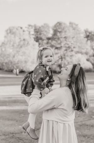 Black and white photo series of a child and adult playing together outdoors in a natural setting.