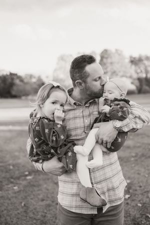 Black and white photo series showing playful family moments outdoors.