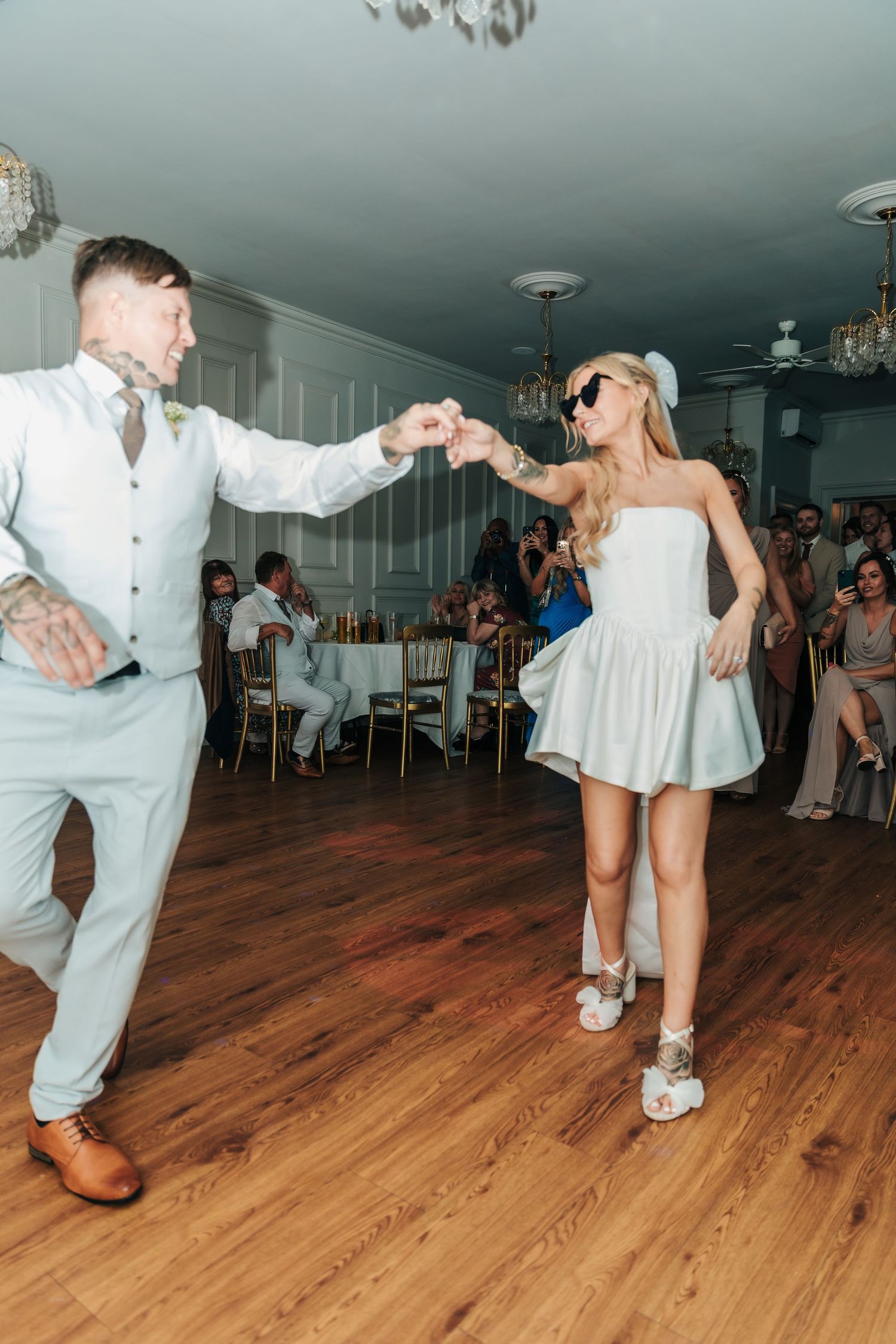Wedding couple performing energetic dance moves on wooden floor. Photographer. Hull. East Yorkshire. Photography