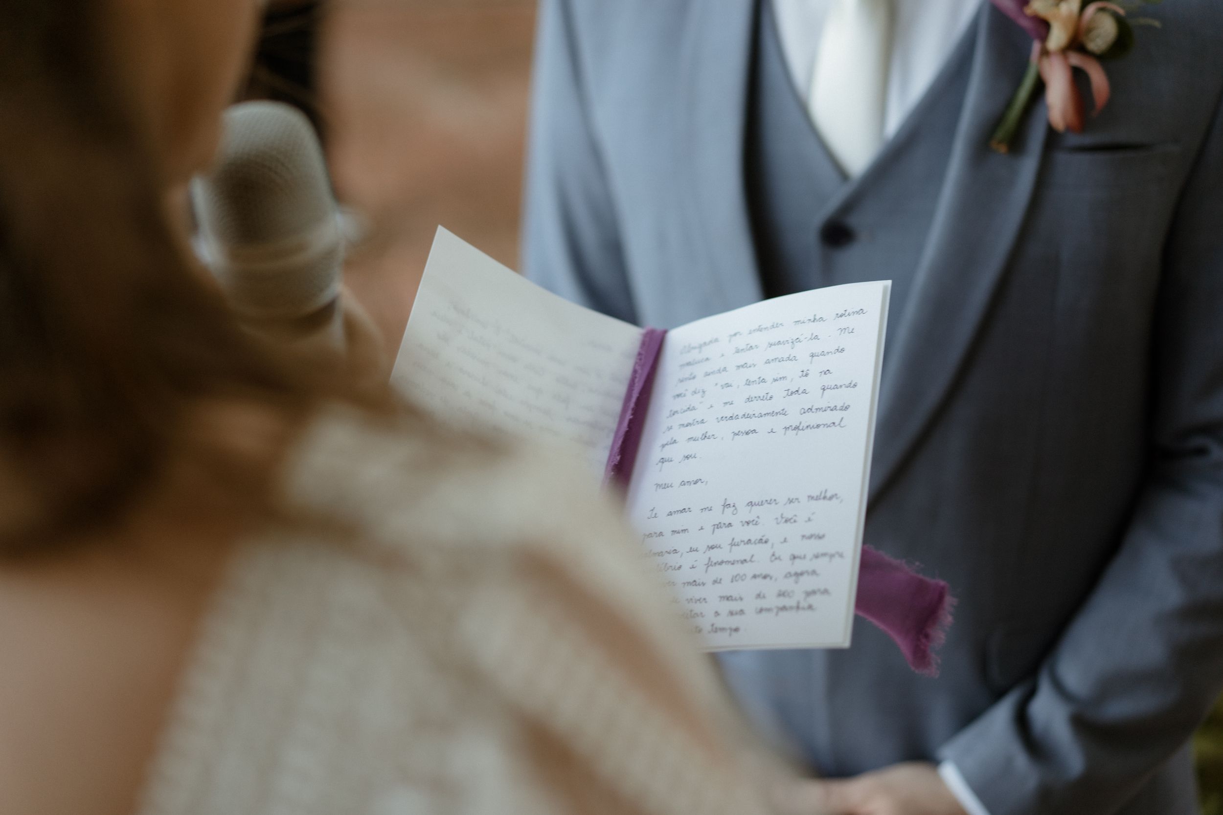 Handwritten vows being read from a paper during a wedding ceremony.