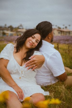 Intimate couple's portrait session in a field of blooming spring wildflowers.