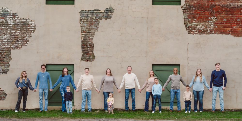 Beige texture wall back drop during a family session.