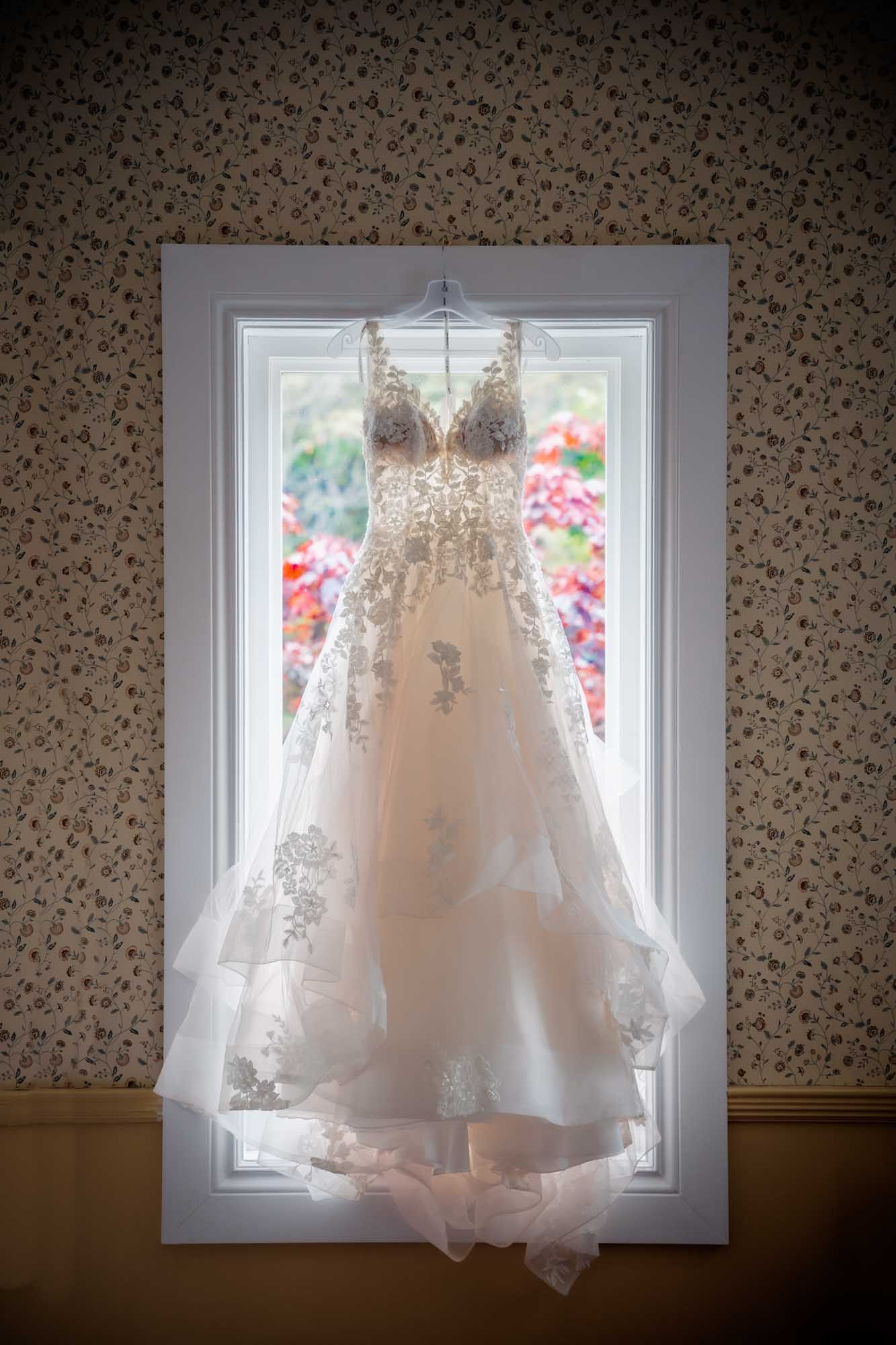 Wedding dress showcasing intricate design details displayed on the window