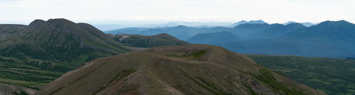 Panoramic mountain range vista stretching across the horizon.