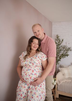 Maternity session of husband embracing wife from behind as they both cradle her baby bump. Wrightstown NJ Maternity Photographer