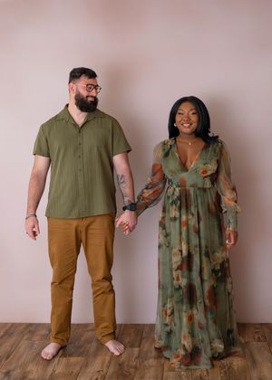 A couple holding hands as he looks at her as she is smiling towards the camera. Wrightstown NJ Family Studio Photographer