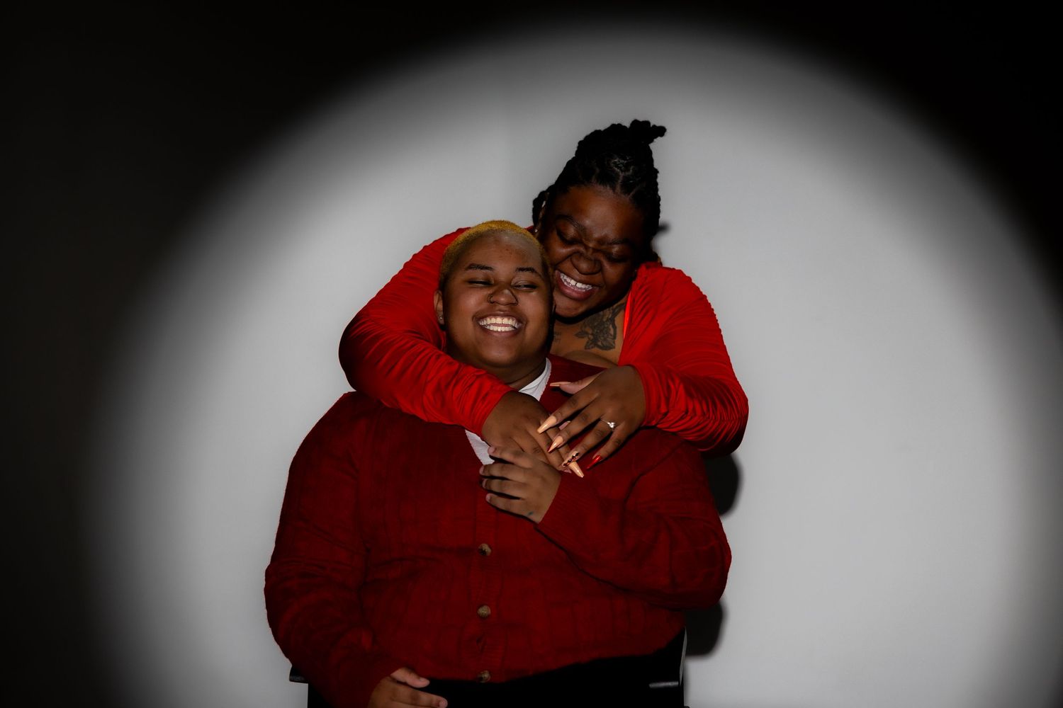 Six candid moments show people in red clothing embracing and laughing together in a joyful sequence.