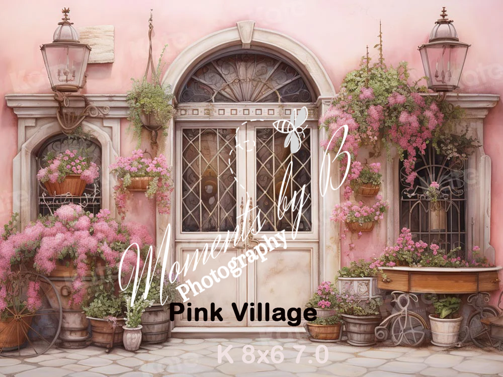 Charming pink facade with ornate wrought iron door, vintage lanterns, and climbing roses adorning the entrance.