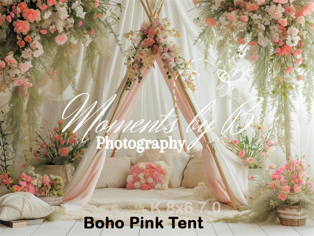 Romantic boho-style tent setup with pink roses, flowing white fabric, and floral arrangements for a dreamy photo backdrop.