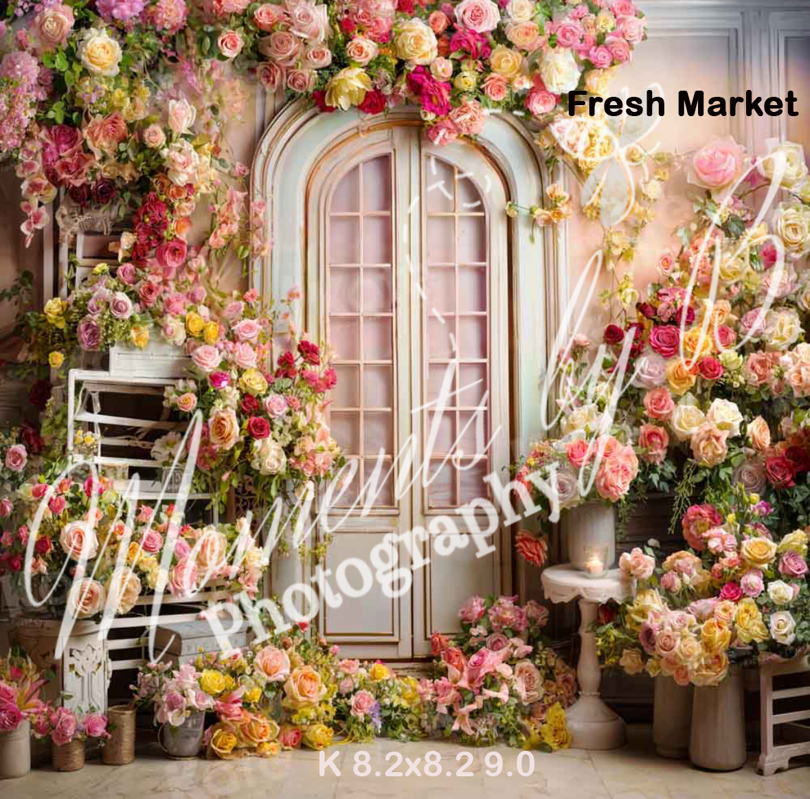 Vintage door frame covered in cascading pink and peach roses with decorative garden accessories.