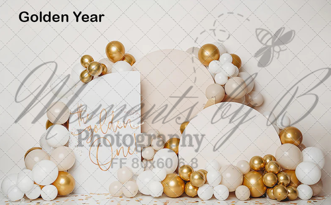 White and gold balloon arch arrangement with elegant party decorations against a neutral backdrop.