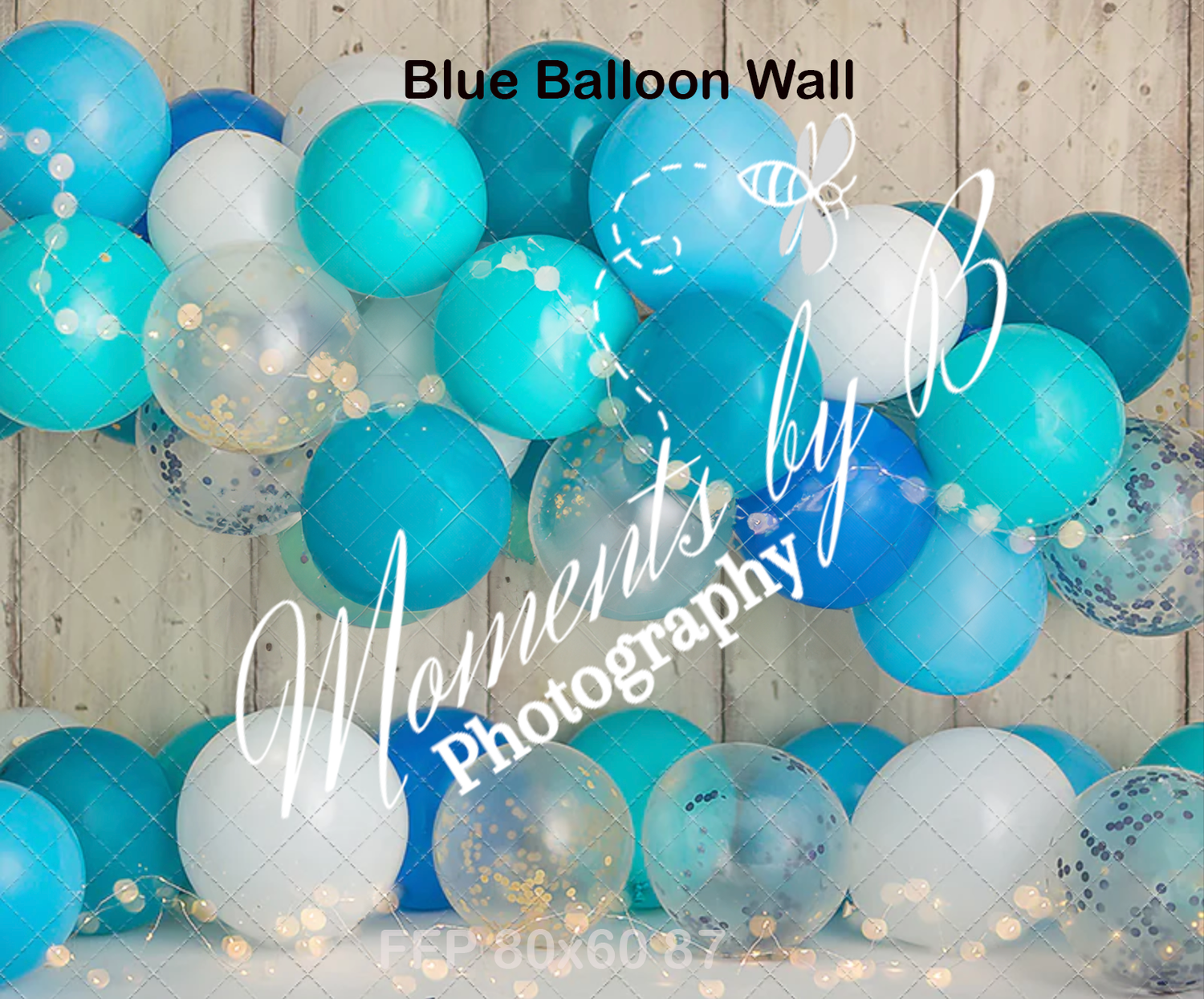 Festive balloon arch arrangement in shades of turquoise blue, white, and silver against wooden backdrop.