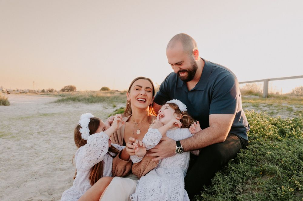 A family shares joyful moments together in a golden sunset field setting.
Altona Family Photographer Melbourne