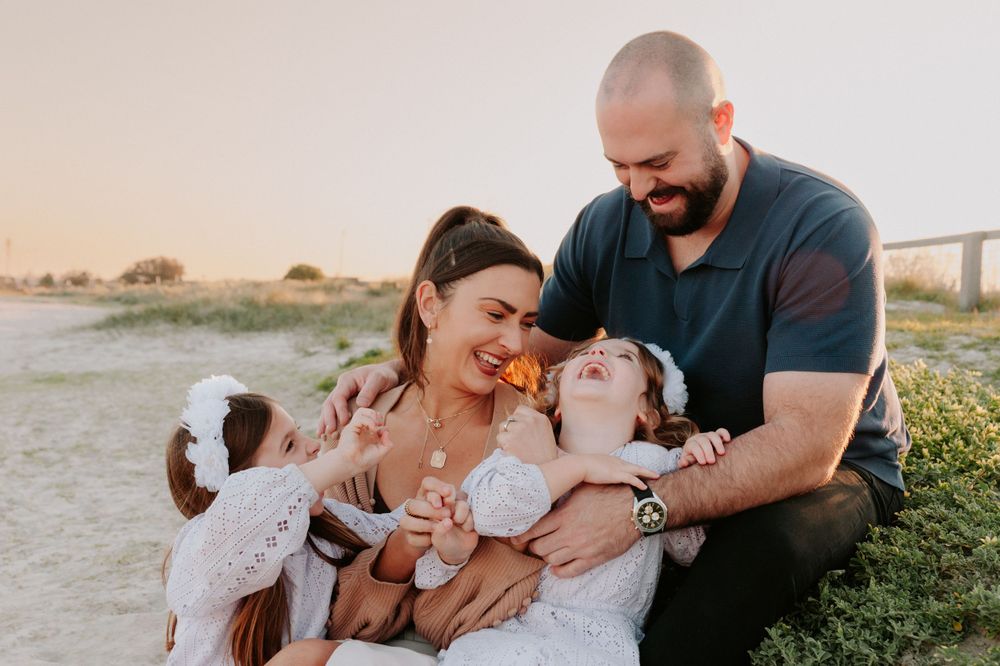 A family shares a candid laughing moment together outdoors against a warm sunset backdrop.
Altona Family Photographer Melbourne