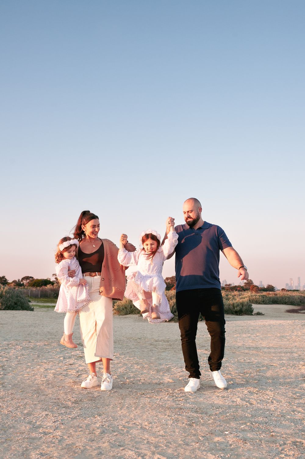 A family walks along a sandy beach during sunset, creating a romantic seaside atmosphere.
Altona Family Photographer Melbourne