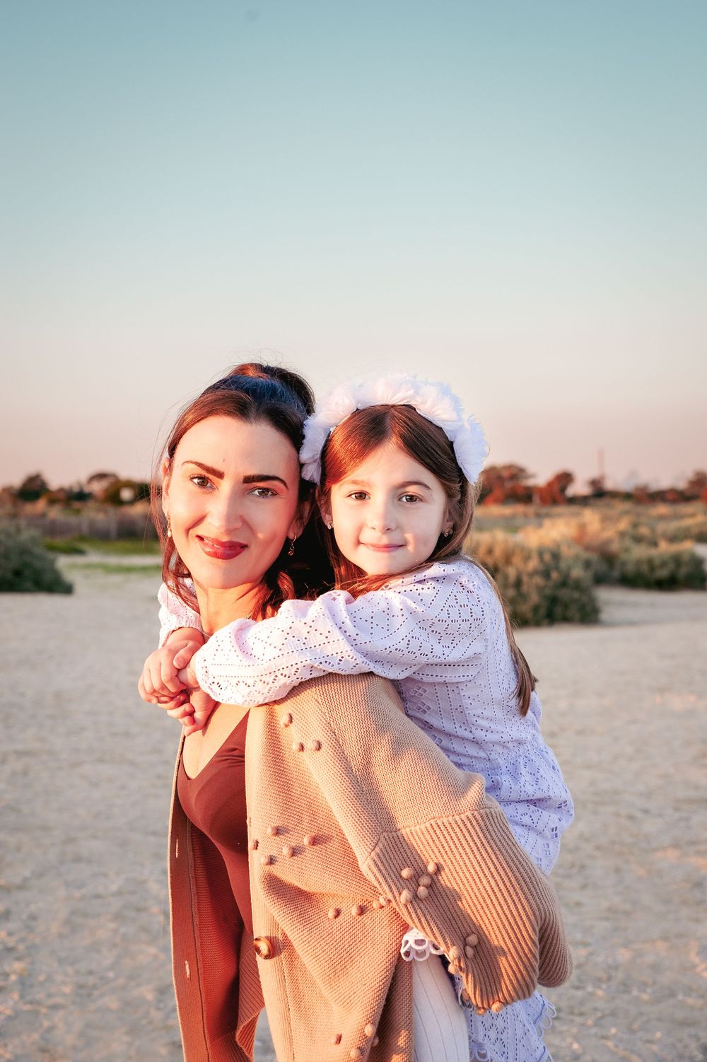 A sweet sunset photo of a parent and child embracing on a beach with golden hour lighting.
Altona Family Photographer Melbourne