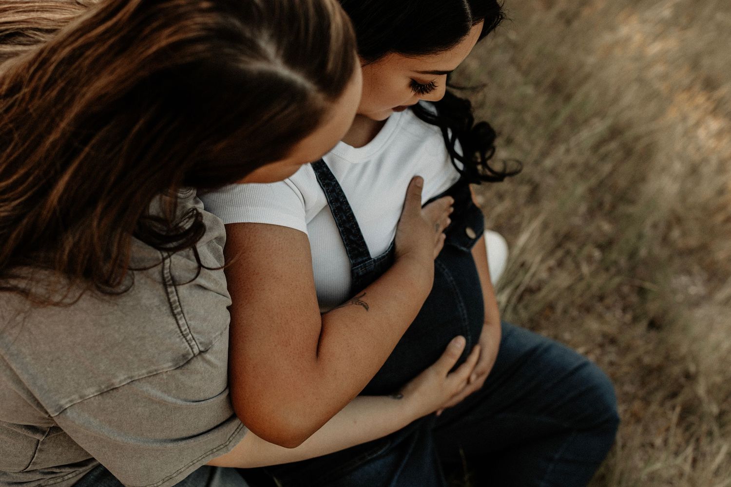Candid outdoor photography session captures intimate moments in a natural setting.