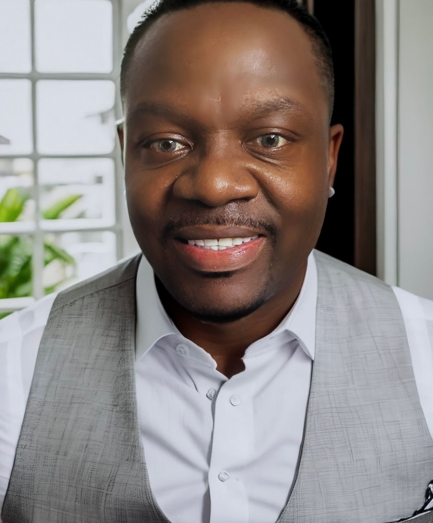 Tommy Curtis Smiling with dress shirt and gray vest on