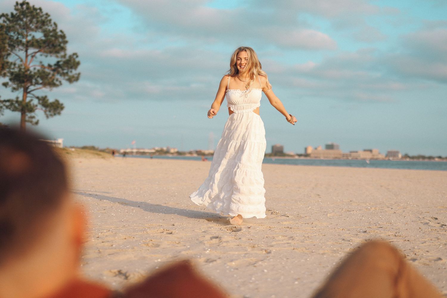 portrait photography of a beautiful young woman running on the beach to her love.