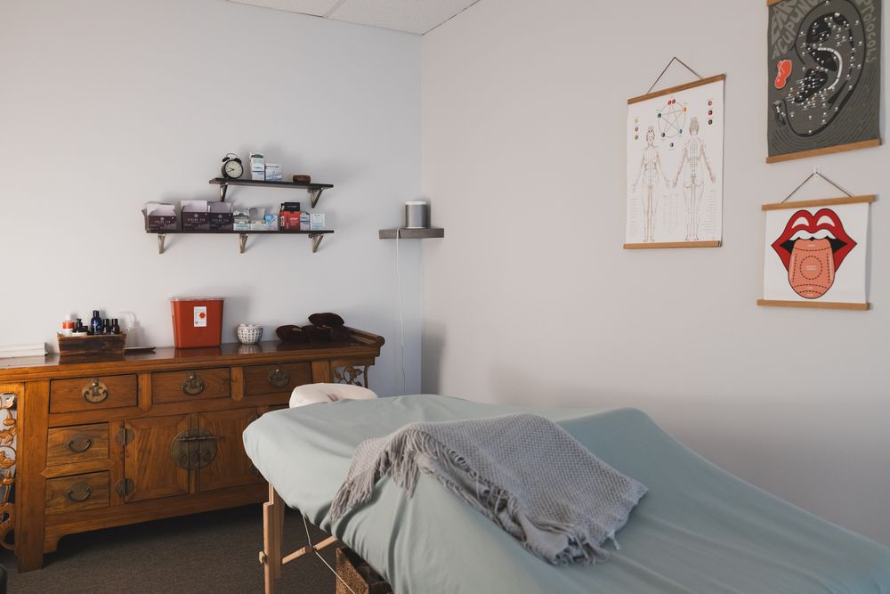 Maple Valley, Acupuncture, WA interior branding of client treatment room of table, wall posters and supplies, tools