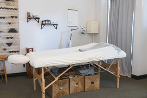 Maple Valley, Acupuncture, WA interior branding of client treatment room of table, wall posters and supplies, tools