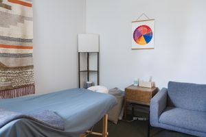 Maple Valley, Acupuncture, WA interior branding of client treatment room of table, wall posters and supplies, tools