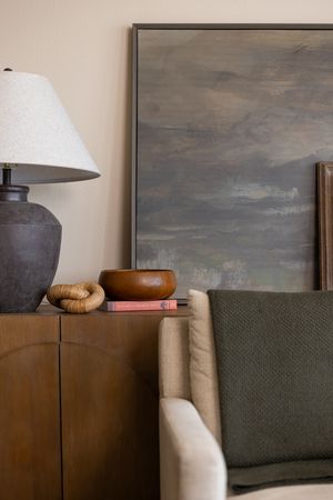 Talks Over Tea Mental health therapist office space in Tacoma, WA detail of cozy warm office chair, lamp, table and art work