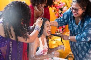 Energetic party scene with people dancing and celebrating against vibrant yellow background.