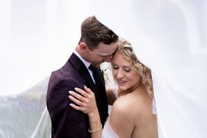 An intimate wedding portrait captured against a misty mountain backdrop.
