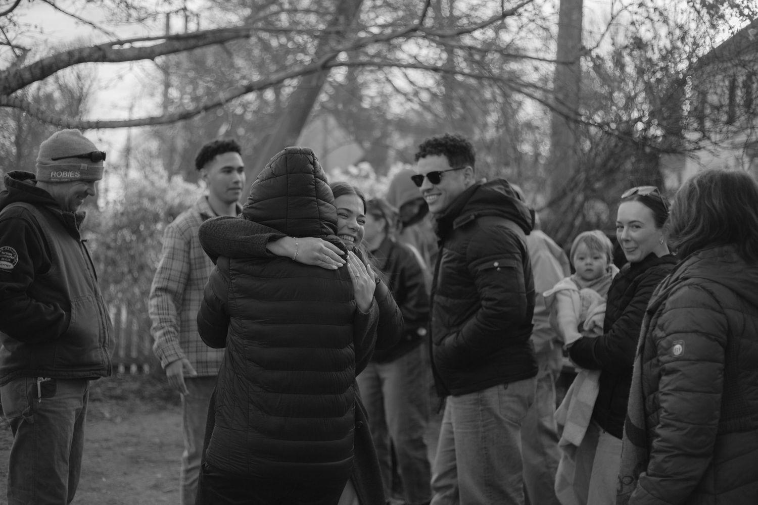 Emotional hug and family gathered around. Southern New Hampshire Generational and Family Photographer Emily Benedict
