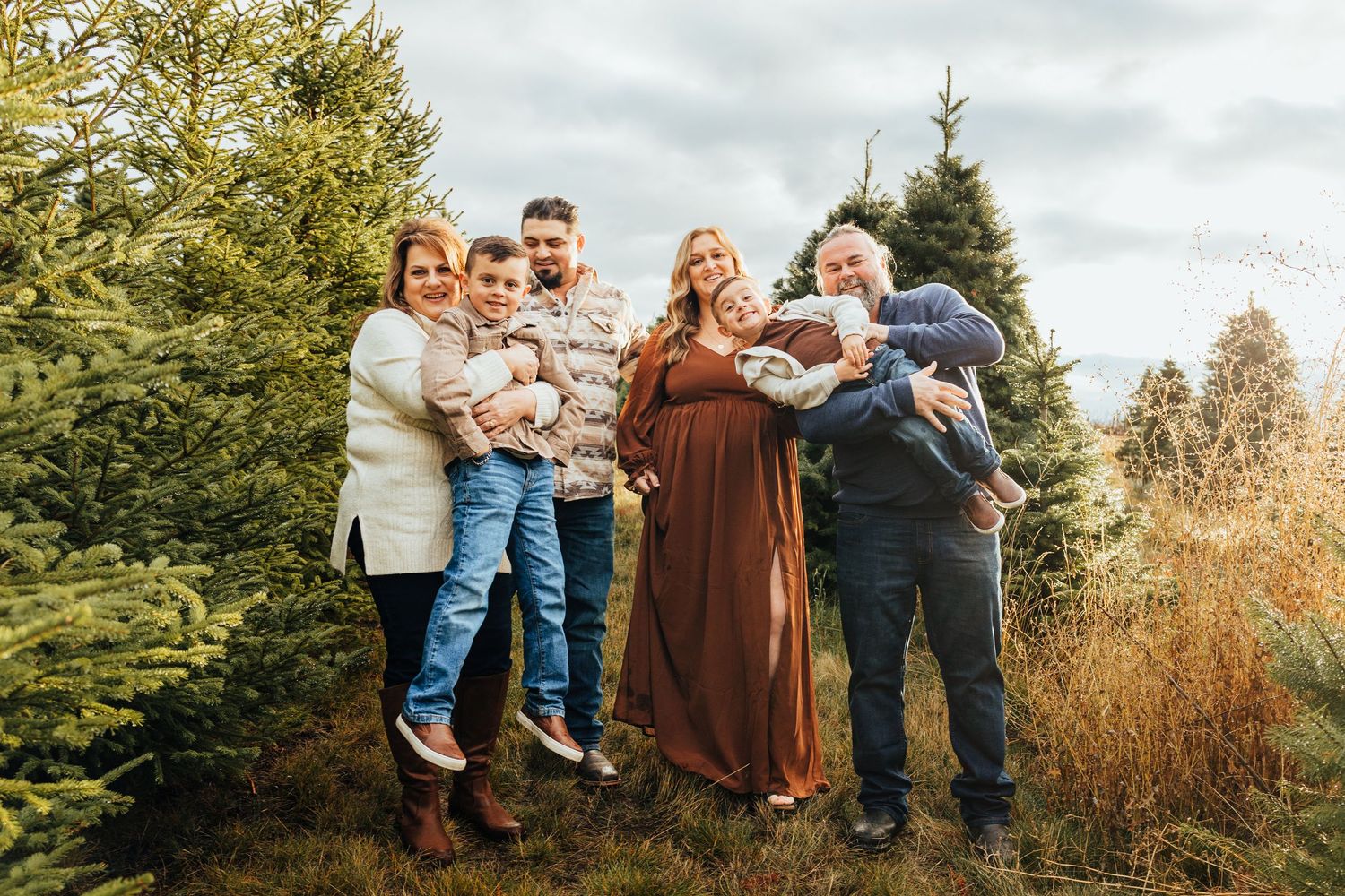 A photo of a family at a Christmas Tree Farm in Walla Walla Washington during sunset