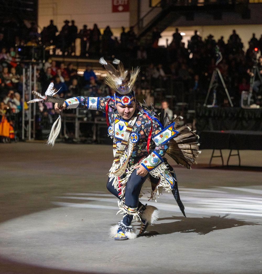 Figure skater performs an athletic jump sequence on ice during a competitive performance.
