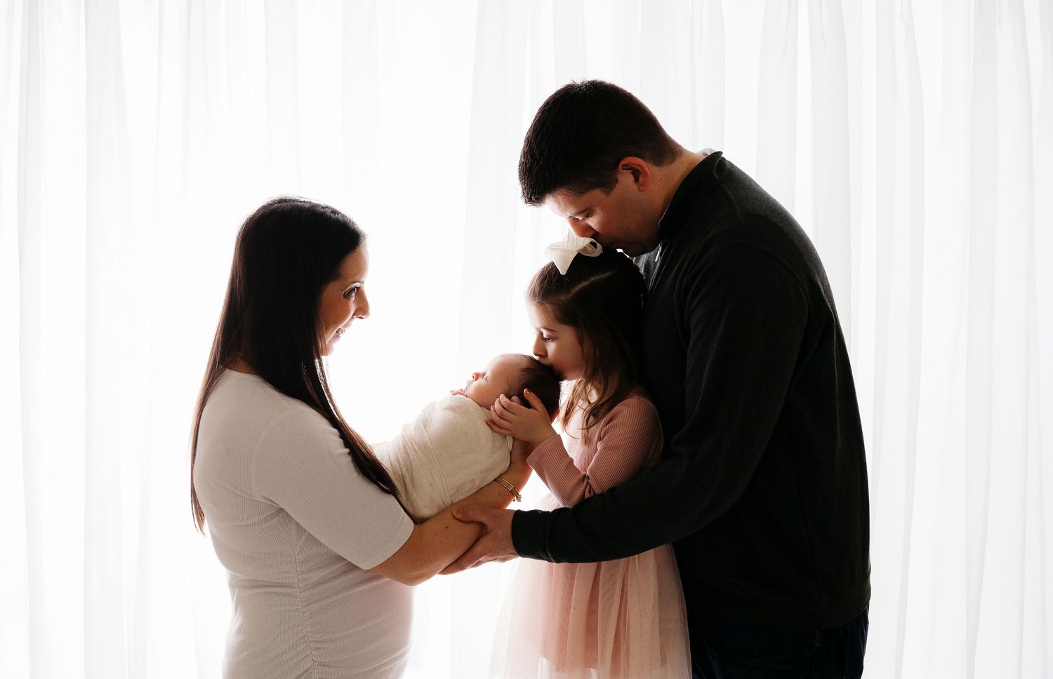 An intimate black and white portrait showing a tender moment of connection and embrace.