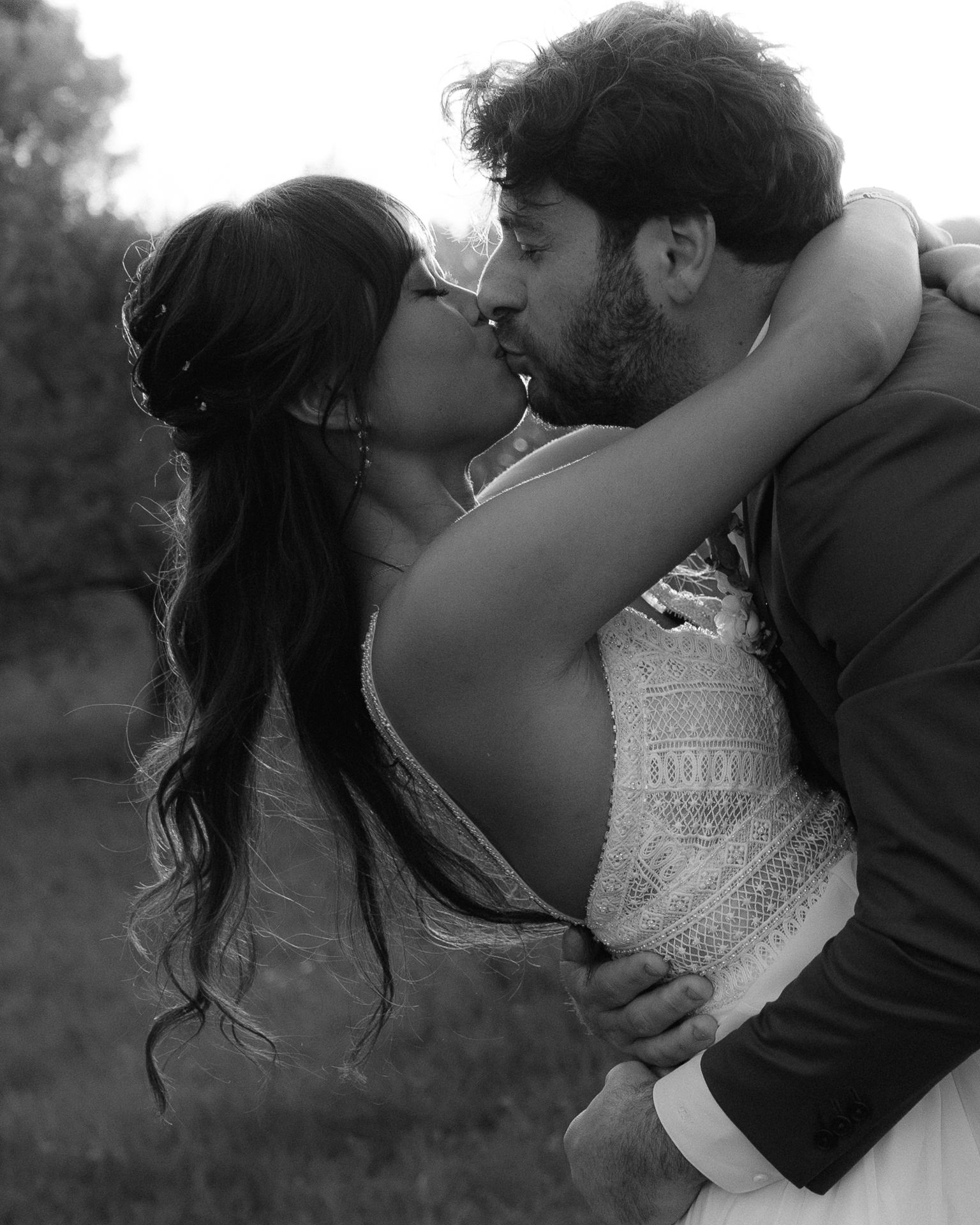 Intimate black and white photo of couple embracing in romantic pose.