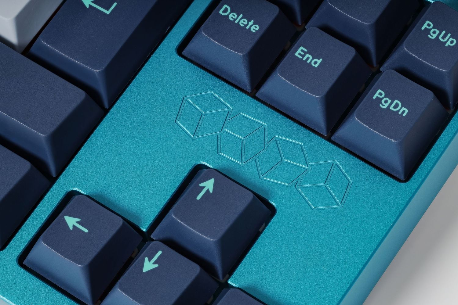 Close-up of turquoise and navy mechanical keyboard keys with geometric design.