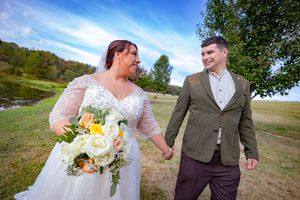 bride and groom walking with picturesque background