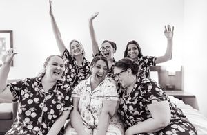 a bride and her bridesmaids gather for a fun picture