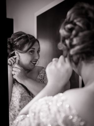 bride takes a moment for finishing touches to her hair and makeup before the ceremony