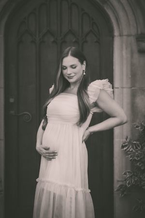 beautiful woman cradles her pregnant belly