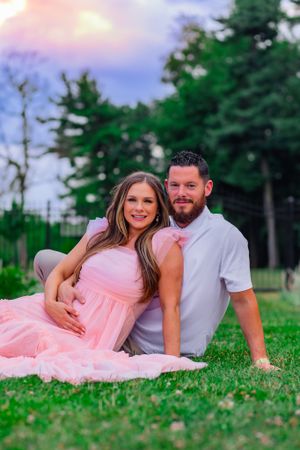 couple cradles pregnant belly