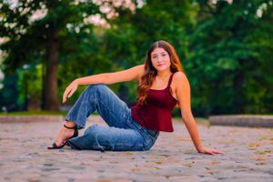 senior girl poses on cobblestone