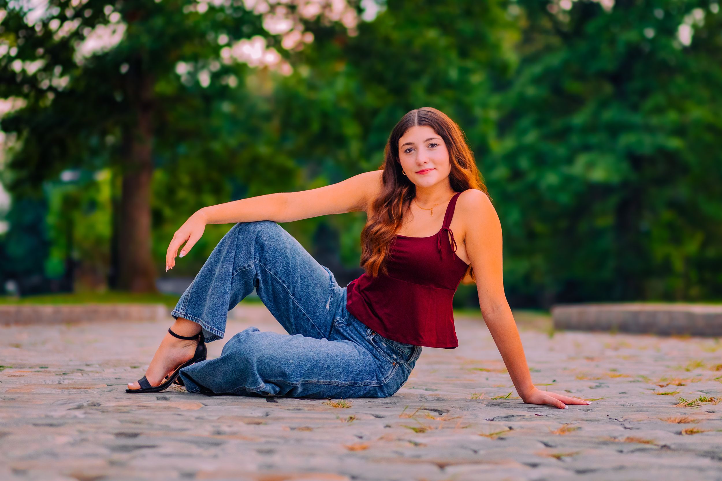 senior girl poses on cobblestone