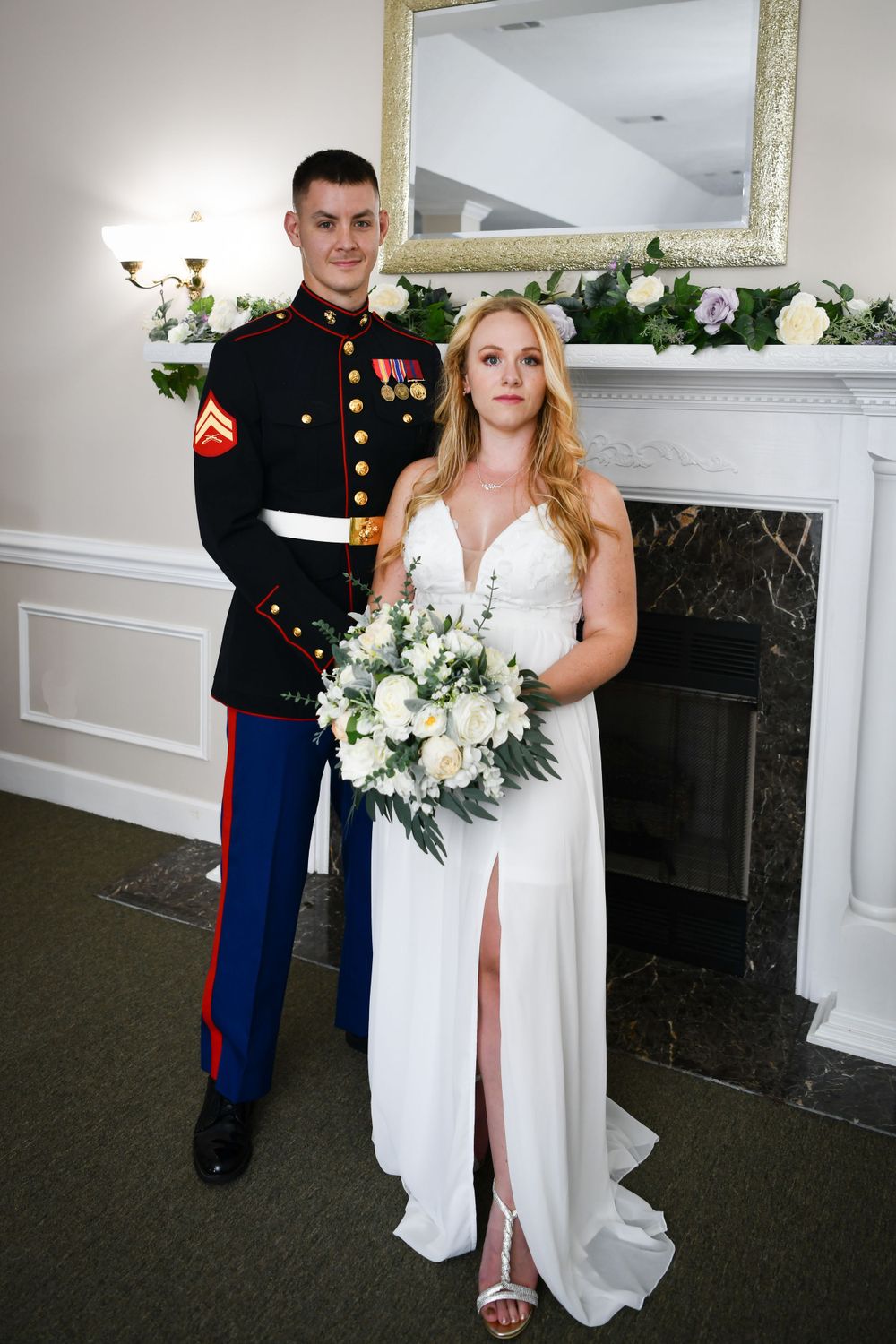 A couple by our elegant venue's fireplace. We offer military discounts for active duty military.