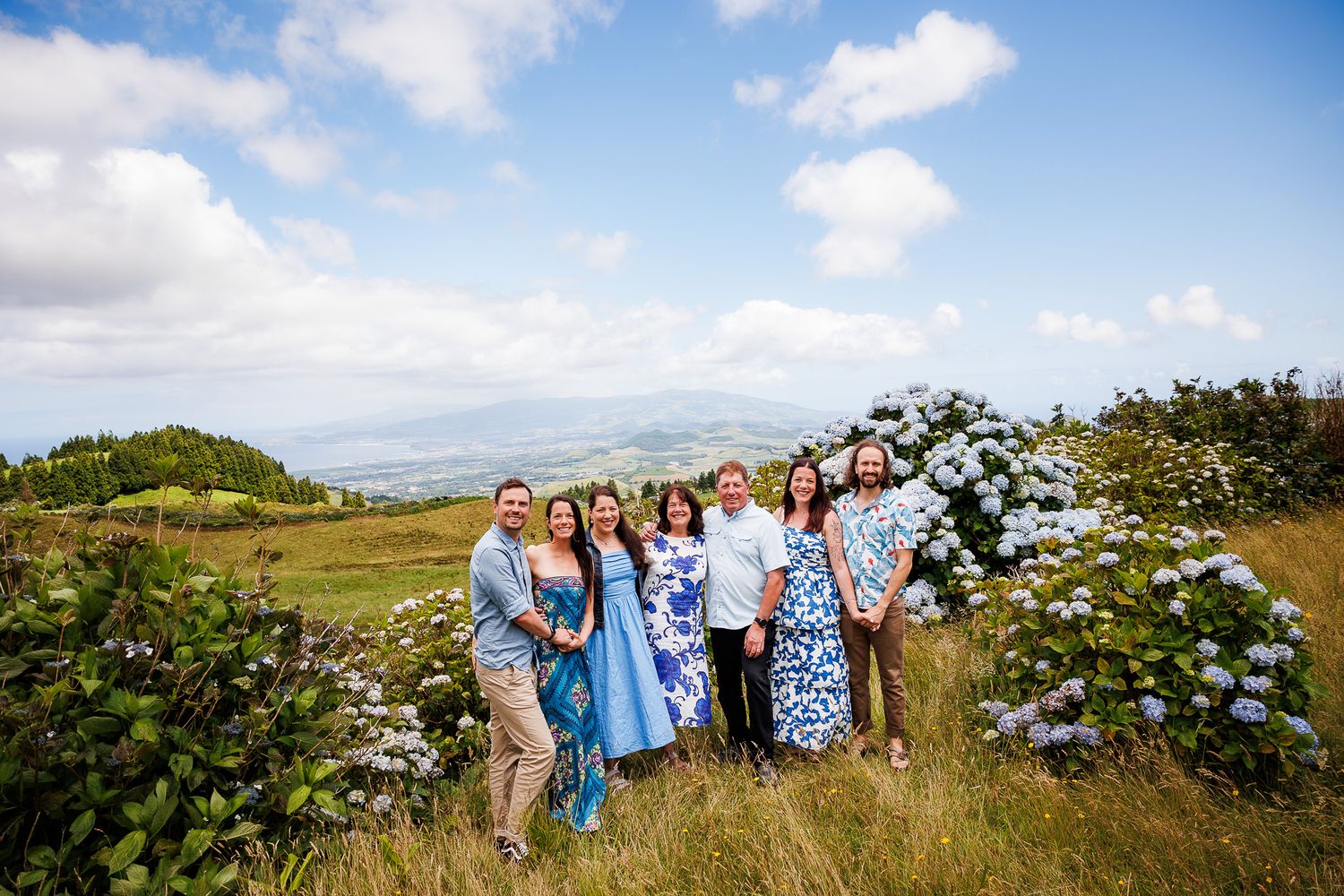 Loving family sharing time together, surrounded by hydrangeas, at São Miguel island, Azores.