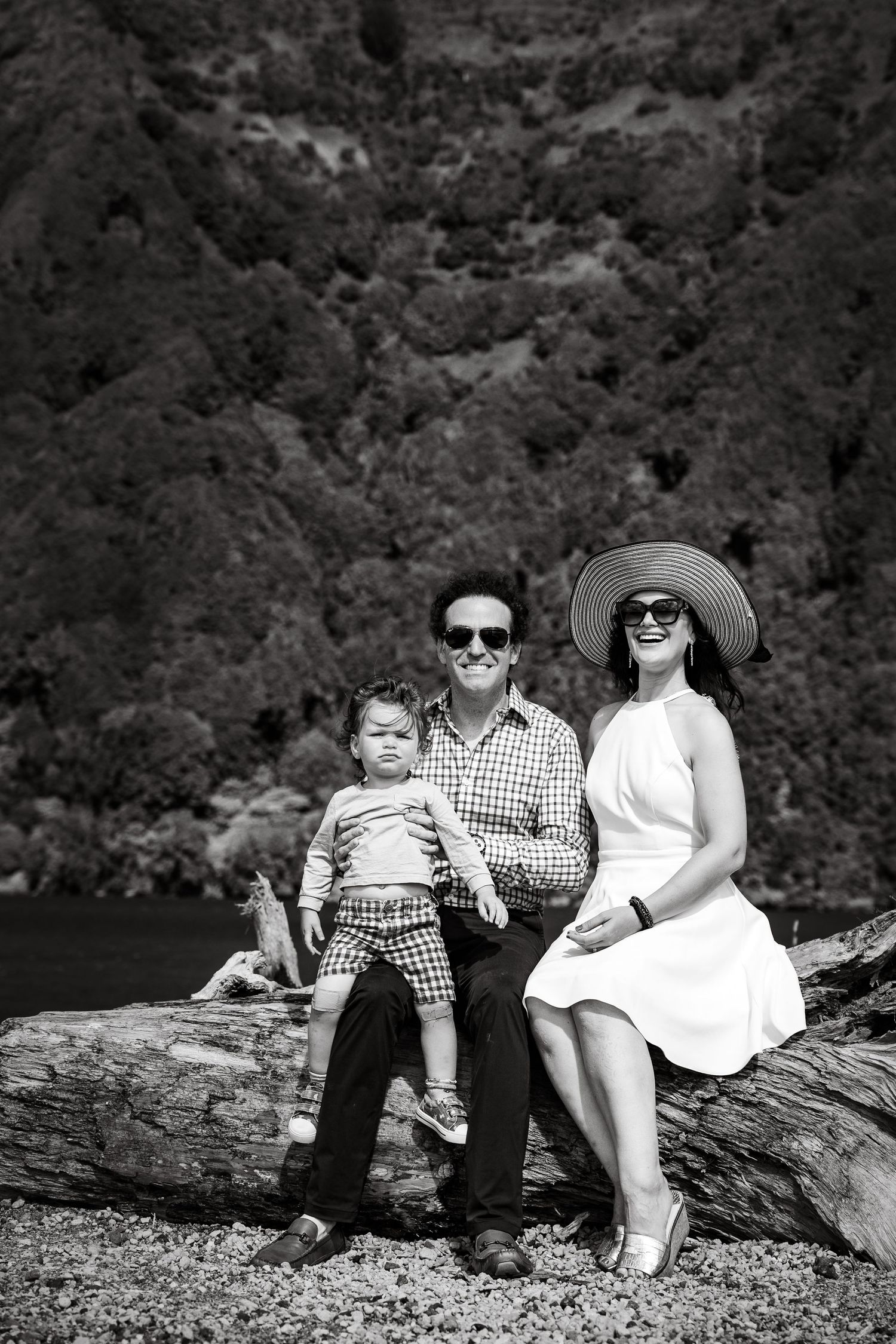Heartwarming family portrait with mountains and trees as the backdrop.