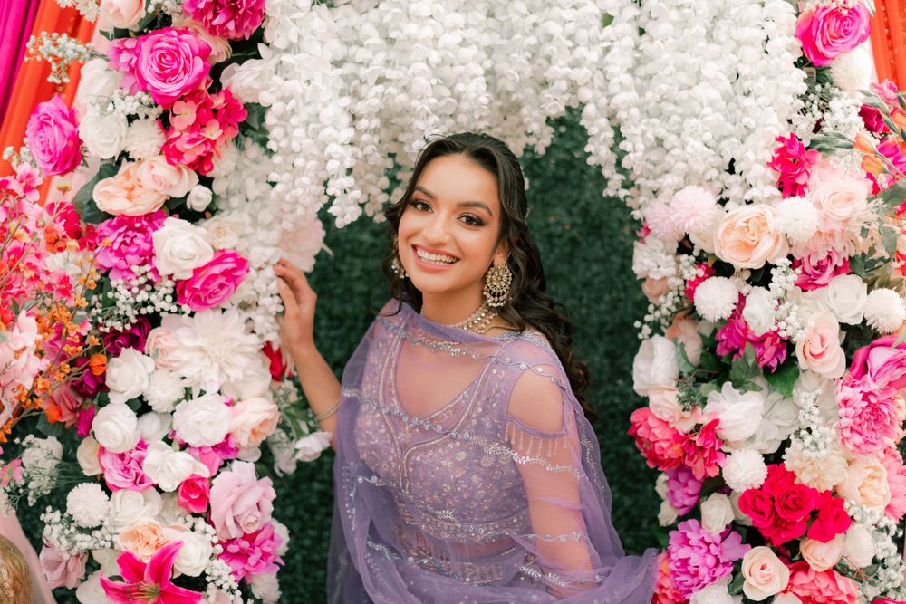 Indian model posing in front of a floral background in Turlock, CA. Photographed by Shumesa Mohsin