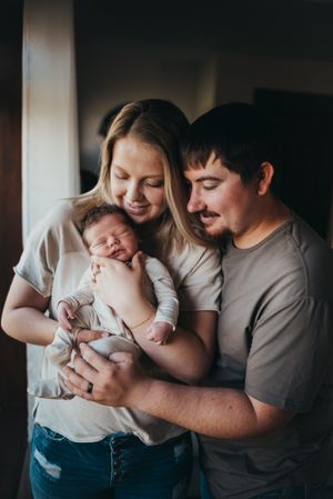 Newborn snuggles captured during a cozy lifestyle session in southwest North Dakota