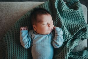 Baby boy sleeping peacefully at home during in-home newborn session near Dickinson, ND
