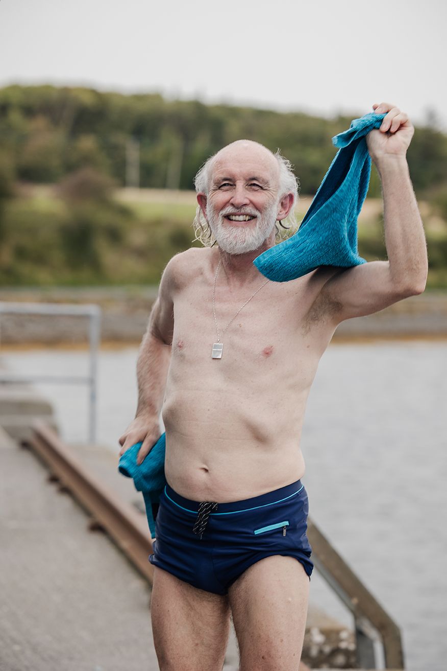 an elderly man drying himself after sauna session
